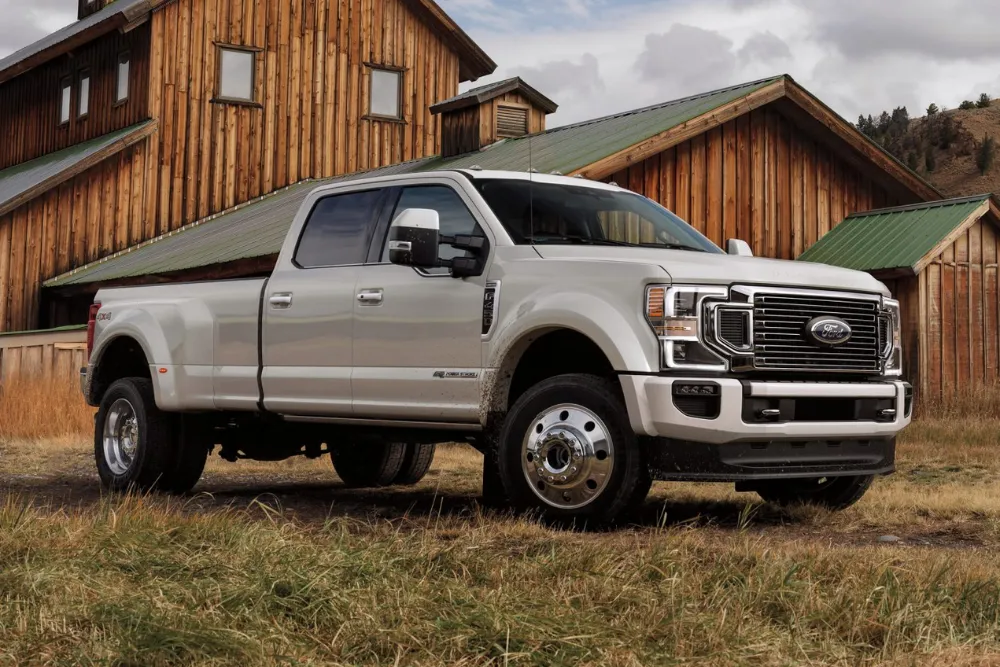 Silver Ford truck near wooden barn