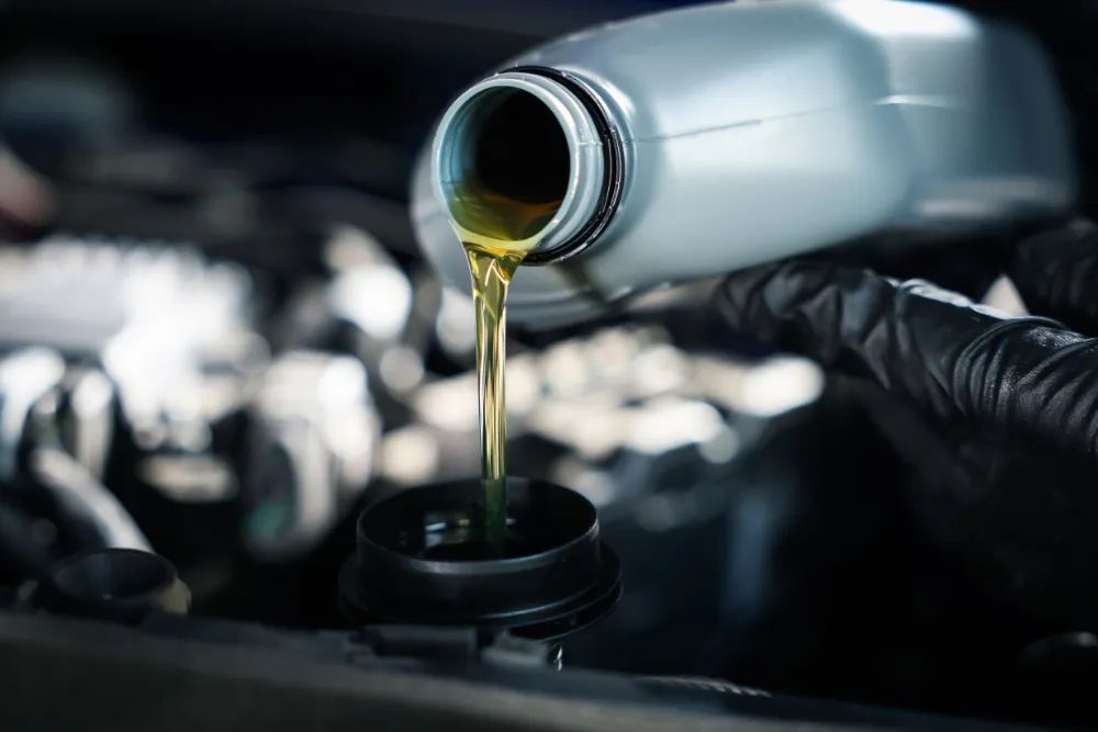 Pouring oil into a car engine