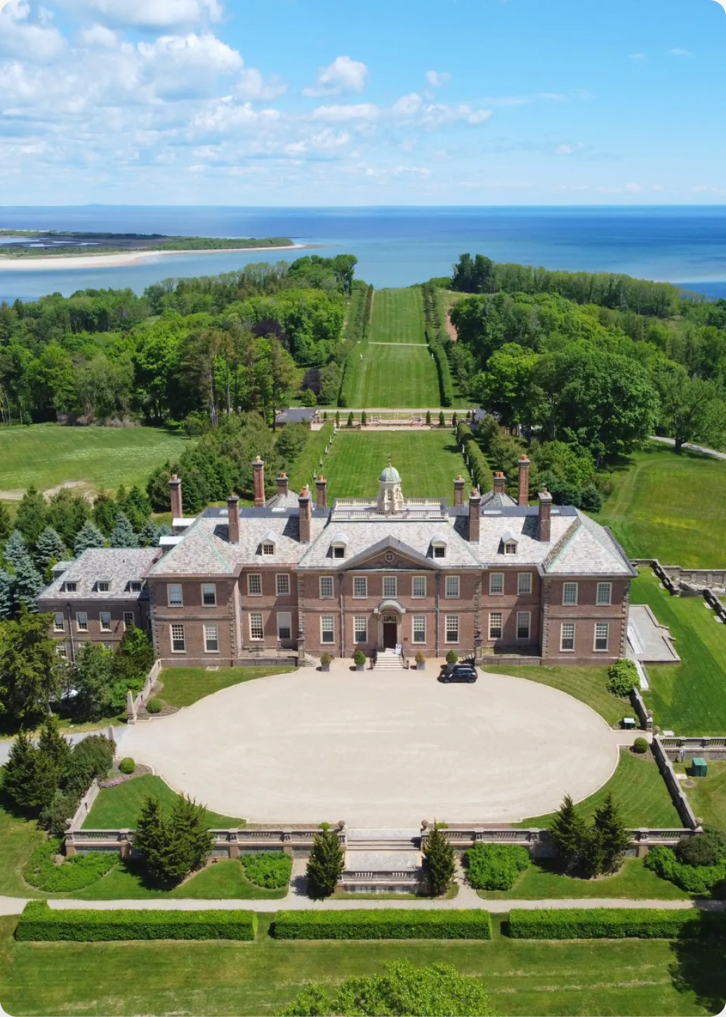 About New Meadows Motor Car Auto Repair in Ipswich MA. Grand mansion overlooking lush landscape.