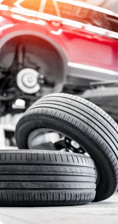 Tire Sales & Services in Ipswich MA At New Meadows Motor Car. Two tires in automotive workshop setting